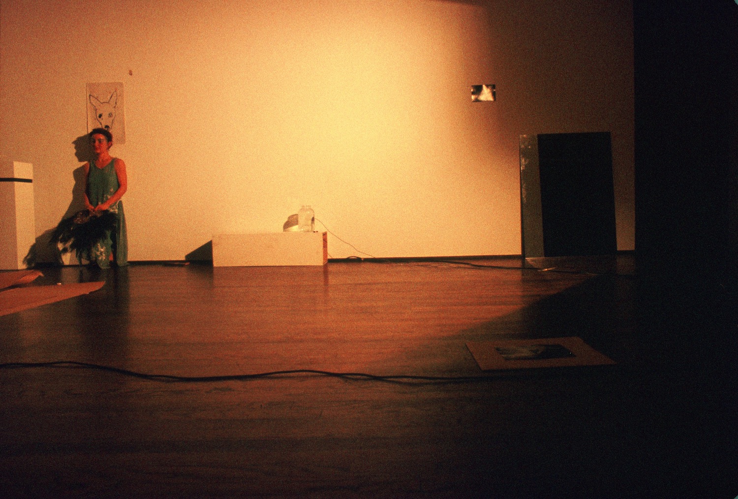 Jonas sitting in a chair in front of a drawing of a dog’s head