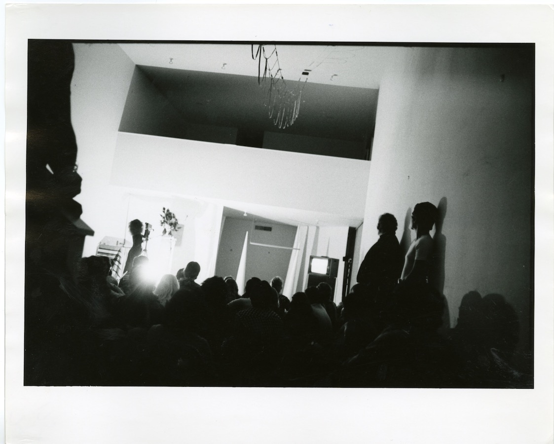 Crowd watching a camerawoman filming Jonas perform with two white cones and a video monitor on a stand