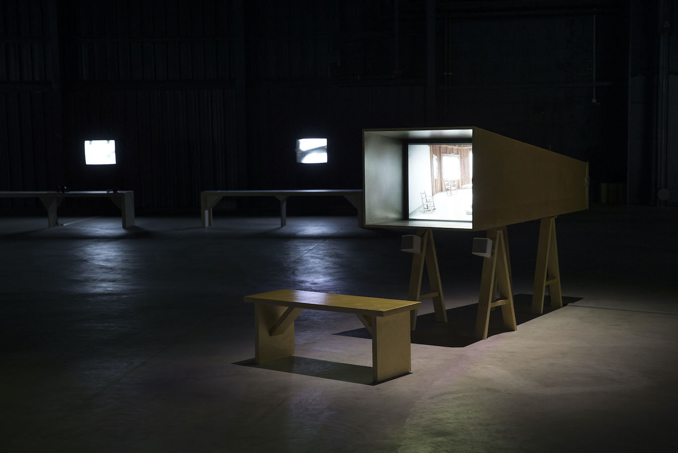 Three benches in front of three TV monitors