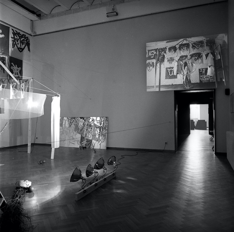 A room filled with various props, above the door frame is a video projection