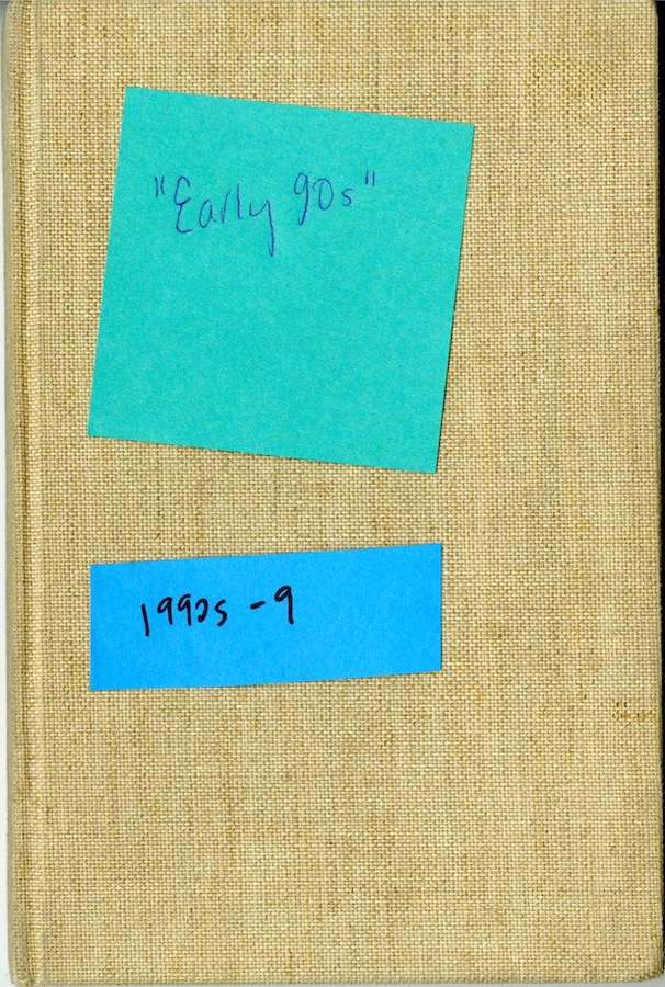 Notebook cover with two sticky notes. Top sticky note reads: “Early 90s”. Bottom sticky note reads: “1990s - 9”.