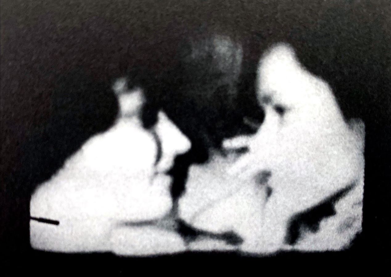 Video still of two women facing each other