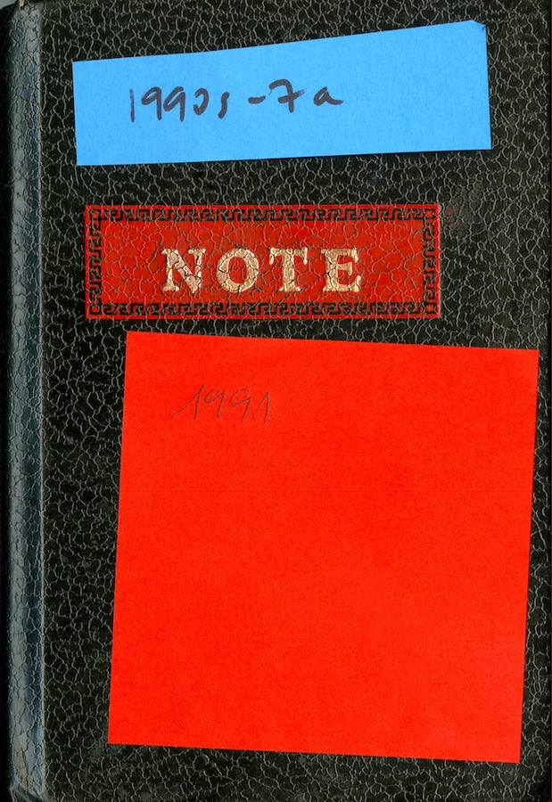 Cover of a notebook with the word “Notes” engraved and two sticky notes. Top sticky note reads: “1990s - 7a”. Bottom sticky note reads “1991”.